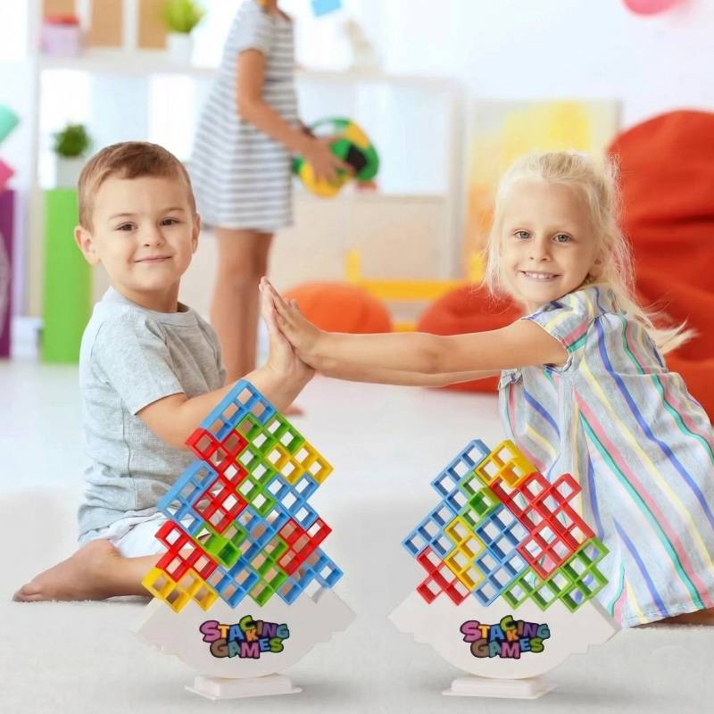 two happy toddlers showing their completed colorful balance towers during a sensory play activity