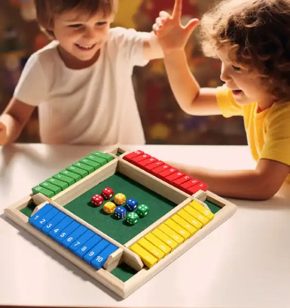 two kids high-fiving while playing the wooden shut the box game to learn math and numbers