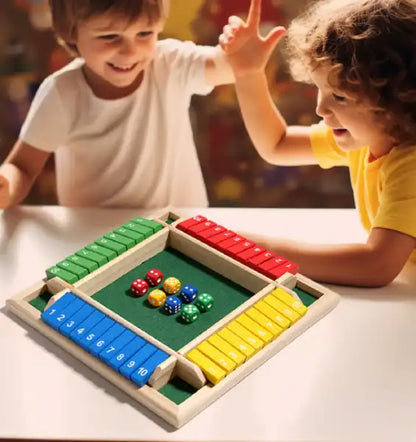 two kids high-fiving while playing the wooden shut the box game to learn math and numbers