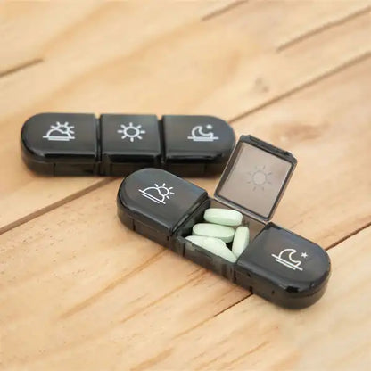 close-up of an individual black pill pod showing morning, noon, and night icons for easy tracking