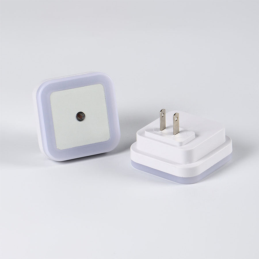 Front and back view of the automatic LED night light showing the sensor and plug.