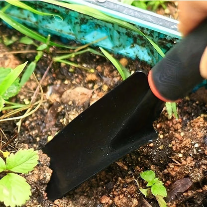 hand gardening trowel planting young seedlings in soil