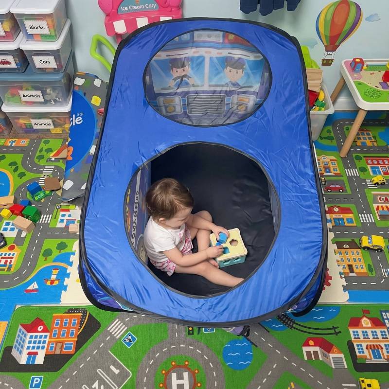overhead view of a child playing inside the spacious interior of the police car pop up tent