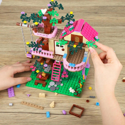 Close-up of hands assembling the intricate levels of the Friends City Tree House building blocks.