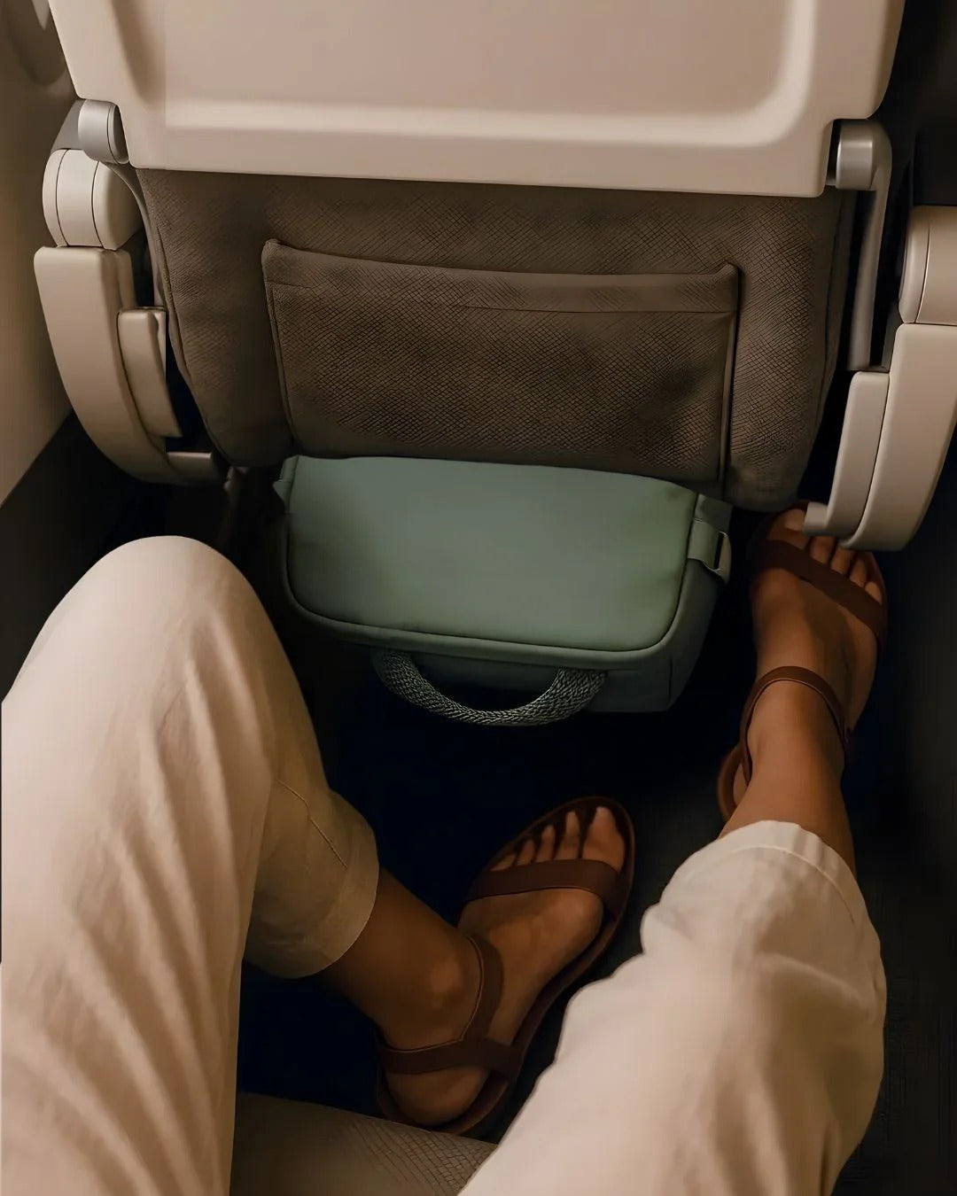compact carry-on backpack stowed under an airplane seat for easy access during flights