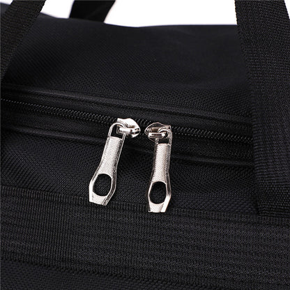 close-up detail of high-quality dual metal zippers on a black water-resistant travel duffel bag