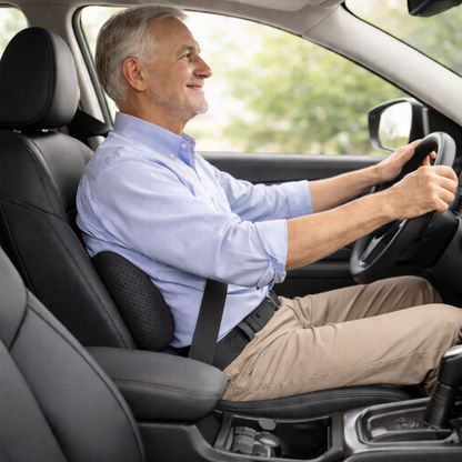 senior man using a memory foam lumbar pillow while driving for better posture and comfort