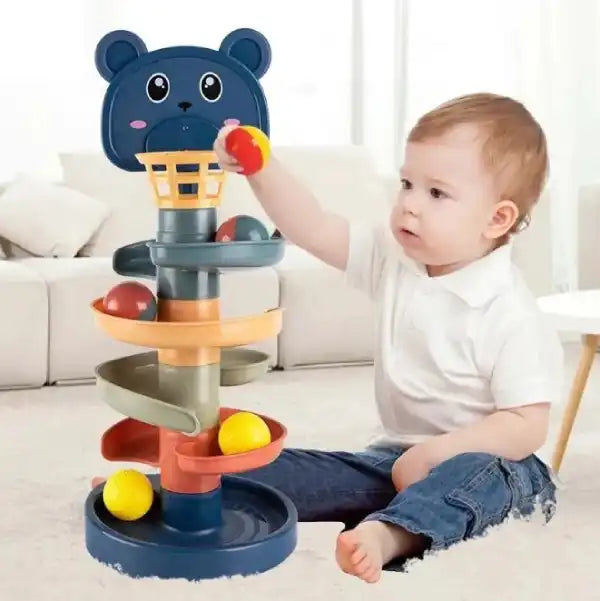toddler reaching for the bear-shaped hoop of the ball drop toy for hand-eye coordination training