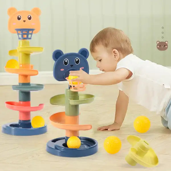 toddler lying on tummy playing with the base of the colorful rolling ball tower tower