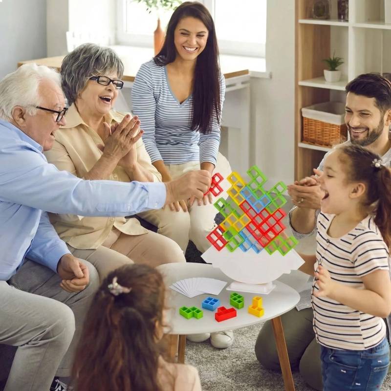 senior grandparents enjoying a fun stacking game session with their grandchildren and parents