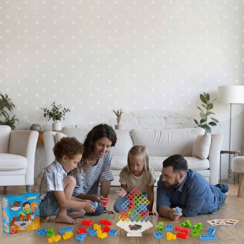 multi-generational family playing a balancing and stacking board game together on the living room floor