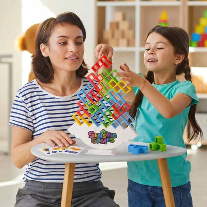 mother and young daughter focusing on a steady hands stacking challenge at a small wooden table
