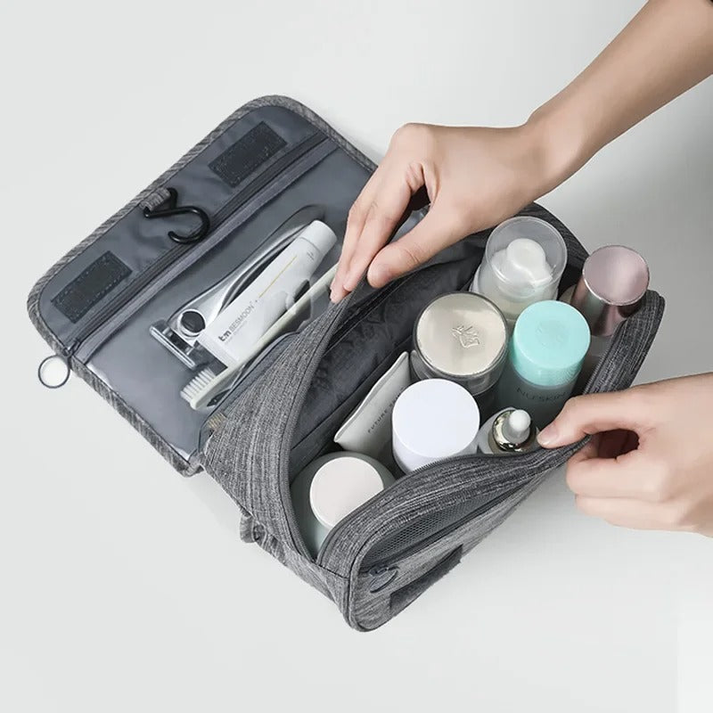 gray hanging toiletry bag opened to show spacious internal mesh pockets and storage capacity