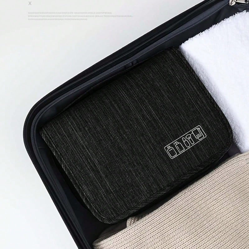 compact black toiletry bag organizer tucked into a suitcase for efficient travel packing