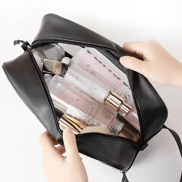 open view of the travel pouch bag showing spacious interior filled with skincare and cosmetic bottles