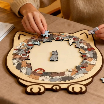 Close-up of hands carefully placing a cat-shaped piece into the wooden cat collage puzzle frame.